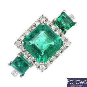 An emerald three-stone and diamond ring.
