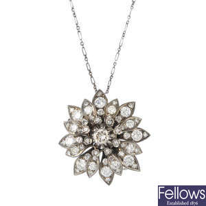 A diamond floral pendant, with chain.