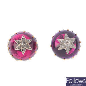 A pair of garnet and diamond earrings.