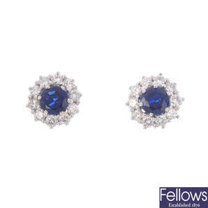 A pair of diamond and sapphire cluster earrings.