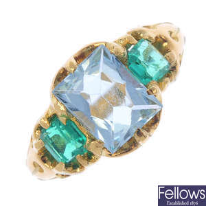 An aquamarine and emerald three-stone ring.