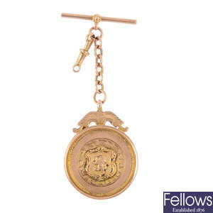A 1920s 9ct gold medallion, with T-bar chain.