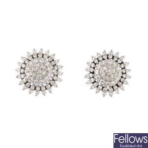 A pair of diamond set cluster earrings.