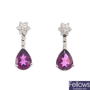 A pair of diamond and garnet earrings.