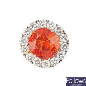 A fire opal and diamond cluster ring.