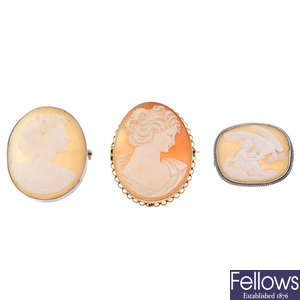 Three cameo brooches and two Wedgwood pendants.