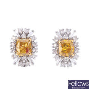 A pair of 'brownish orangy yellow' diamond and diamond cluster earrings.