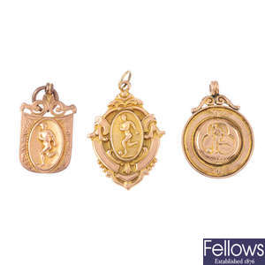 Three early 20th century 9ct gold football medallions.
