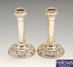 A pair of early 20th century silver mounted candlesticks.