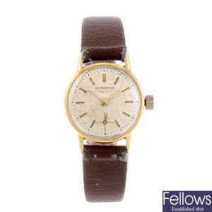 LONGINES - a lady's yellow metal wrist watch.