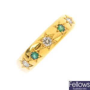 A 22ct gold diamond and emerald band ring.