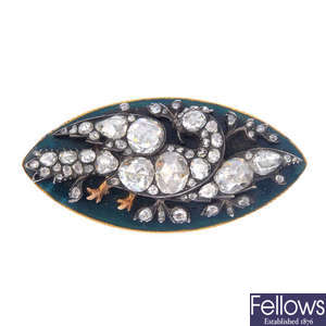 A diamond and enamel brooch.