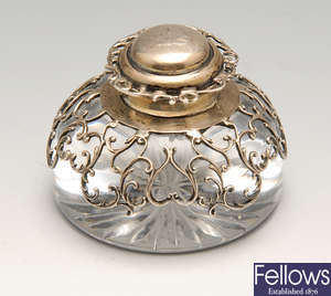 An Edwardian silver mounted inkwell, a silver mounted travelling pocket watch case, etc.