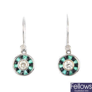 A pair of diamond, emerald and gem-set earrings.