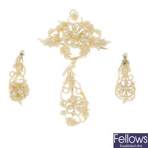 An early 20th century mother-of-pearl and seed pearl brooch and earrings set.