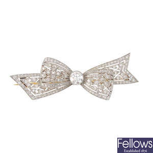 A platinum and 18ct gold diamond bow brooch.