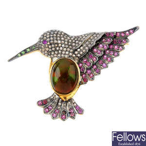 A gem-set bird brooch.