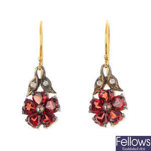 A pair of diamond and garnet earrings.