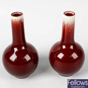 A small pair of Chinese porcelain sang-de-boeuf glaze bottle vases