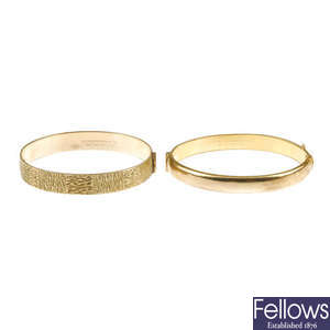 Two rolled gold bangles.