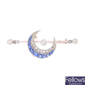 A diamond, sapphire and seed pearl crescent brooch.