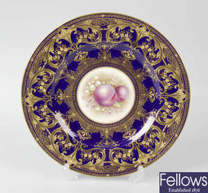 A Royal Worcester porcelain fruit-painted plate, blue border (plum)