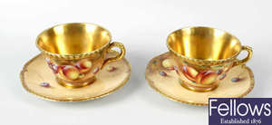 A pair of Royal Worcester porcelain fruit-painted tea cups and saucers by Roberts