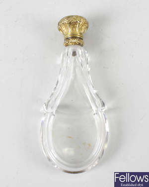 A gold topped scent bottle.