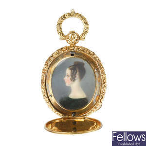 An early Victorian 9ct gold hand painted portrait memorial pendant.