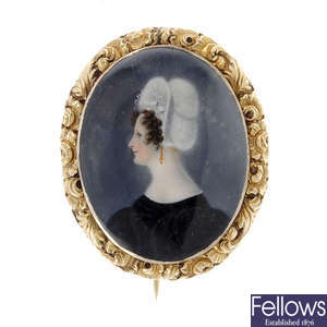 An early 19th century gold, hand painted portrait brooch. 