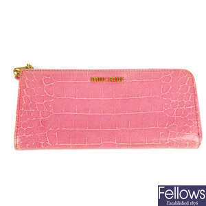MIU MIU - a pink embossed long wallet.