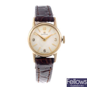 OMEGA - a lady's gold plated wrist watch with a silver full hunter pocket watch.