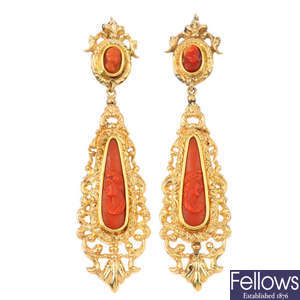 A pair of coral cameo earrings.