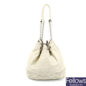 CHANEL - a cream leather drawstring bucket handbag.