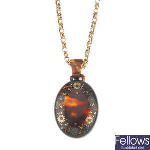 A late 19th century tortoiseshell pique locket with a 9ct gold chain.