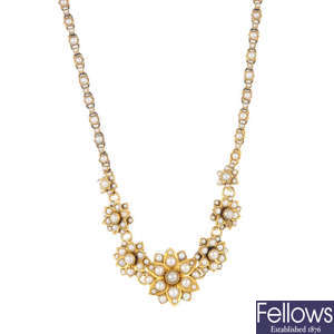An early 20th century gold split pearl necklace.