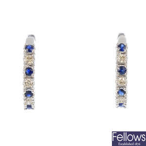 A sapphire and diamond pendant and earrings.