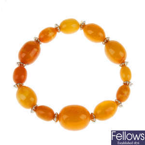 A natural amber bracelet and pair of earrings, AF.