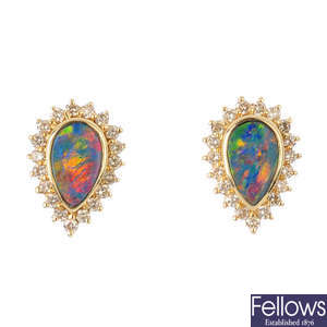 A pair of opal doublet and diamond cluster earrings.