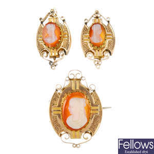 A cameo brooch and earring set.