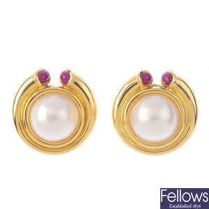 A pair of mabe pearl and ruby earrings.