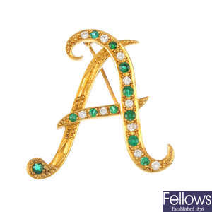 An 18ct gold emerald and diamond initial brooch.