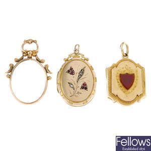 Two lockets and a photograph pendant.