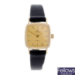 GARRARD - a lady's 9ct yellow gold wrist watch.