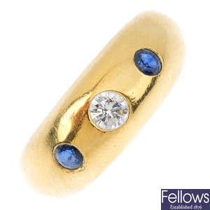 (549027-3-B) CARTIER - a diamond and sapphire three-stone ring.