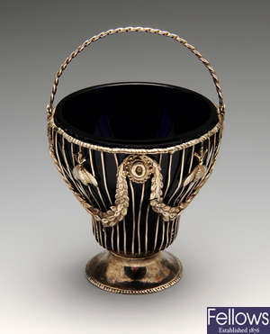 A George III silver pierced basket with swing handle & glass liner.