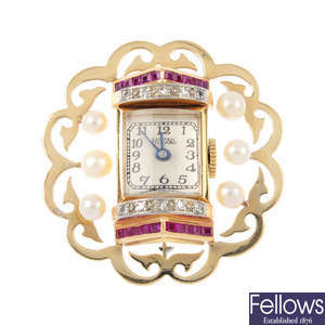 A diamond, ruby and cultured pearl watch brooch.