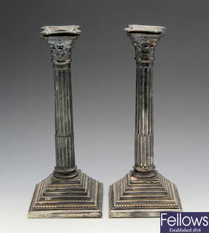 A pair of mid-20th century Corinthian column silver candlesticks.