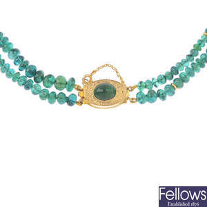 An emerald two-row necklace.