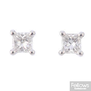 A pair of 18ct gold square-shape diamond single-stone stud earrings.